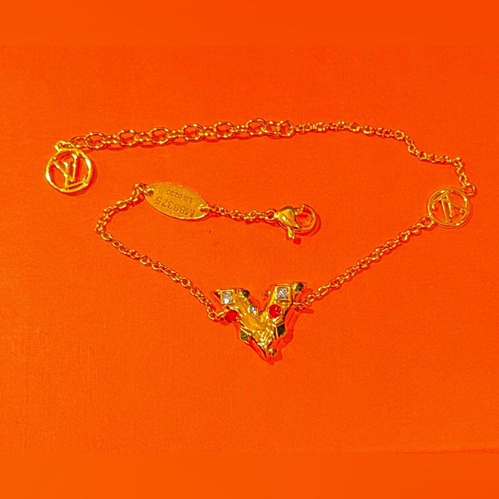 Louis Vuitton V Bracelet gold with multi color beads. Very nice piece. Adj size